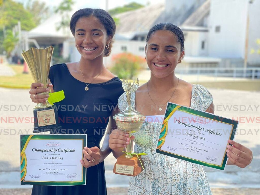 SISTERS Tasmin-Jade King, left, and Zahra-Lys King display trophies and certificates won at recent  the 2024 TT Music Festival. - Photo by Sean Douglas