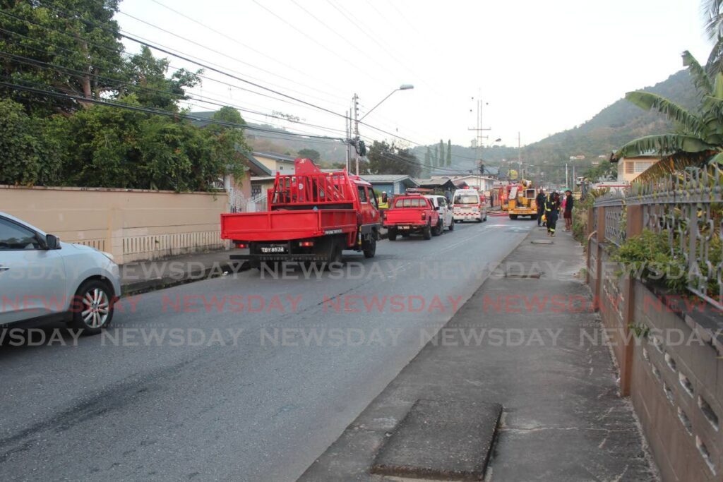 Emergency services, fire trucks and a TTEC truck were at the scene of a house fire on Majuba Cross Road, Petit Valley on March 21.  - Photo by Sydney  Joseph