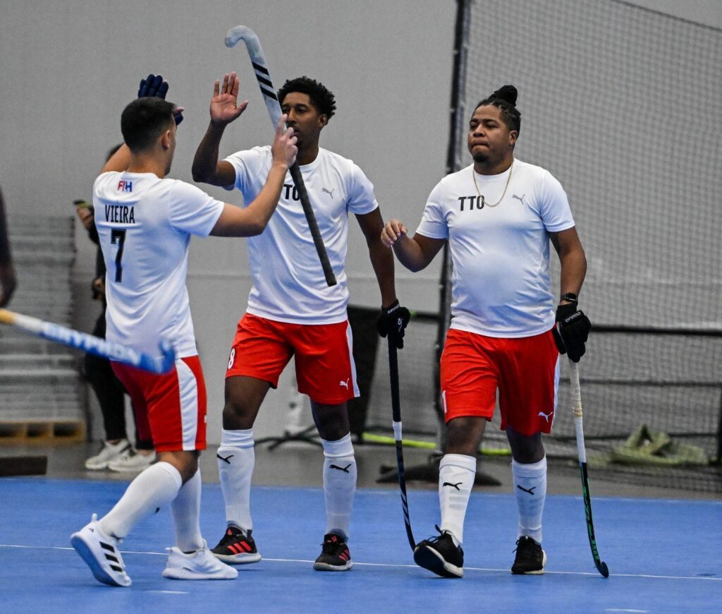 Trinidad and Tobago hockey men celebrate a field goal against USA in the Indoor Pan Am Cup in Calgary, Canada on March 22. - Photo courtesy Pan Am Hockey Federation
