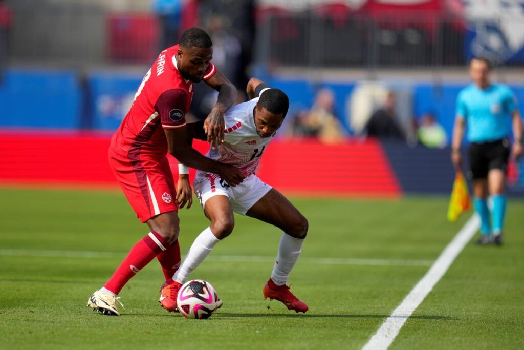 Canada forward Cyle Larin, left, and TT defender Shannon Gomez, right, compete for control of the ball in the first half of a Concacaf Nations League Play-In match, on March 23, 2024, in Frisco, Texas. - AP PHOTO