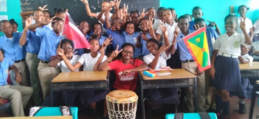 Back-ah-yard’s founder Dixie-Ann Joseph, centre, with pupils of St John’s Anglican Primary, Guave, Grenada, participating in the Poetry and Creative Arts in the Classroom, Community and Online (Paccco) programme.
 - 