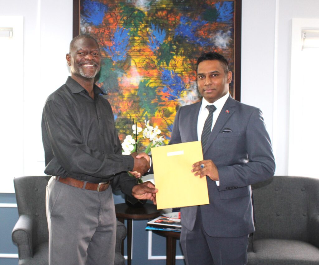 Chief Personnel Officer Dr Daryl Dindial presents HR Adviser Reynold Hinds (L) with his appointment letter at the Office of the CPO on March 22. - 
