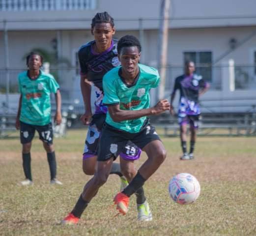 An MIC Matura United player tries to evade his Crown Trace FC opponent during their Central Zone boys’ under-16 clash in the Republic Cup National Youth Football League in UWI, St Augustine on March 24. - Photo courtesy Republic Cup
