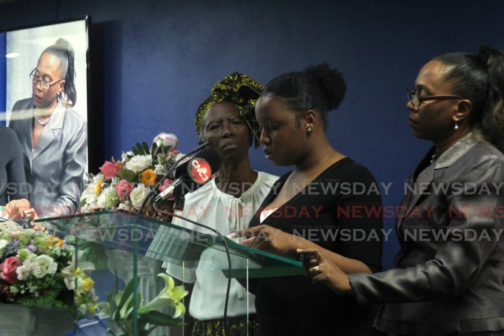 Pastor Una Lowetha-Thomas and another family member support the daughter of Rudolph Donny Jr. James as she gives the eulogy at the OP Allen Funeral Directors Chapel, Eastern Main Rd, San Juan on March 28. - Photo by Faith Ayoung
