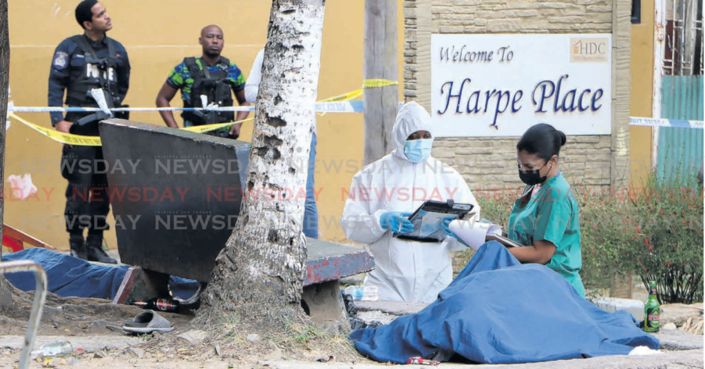 Police at the scene of shooting at Harpe Place, Obseratory Street, Port of Spain on March
16 where five people were killed and three injured. - Photo by Angelo Marcelle