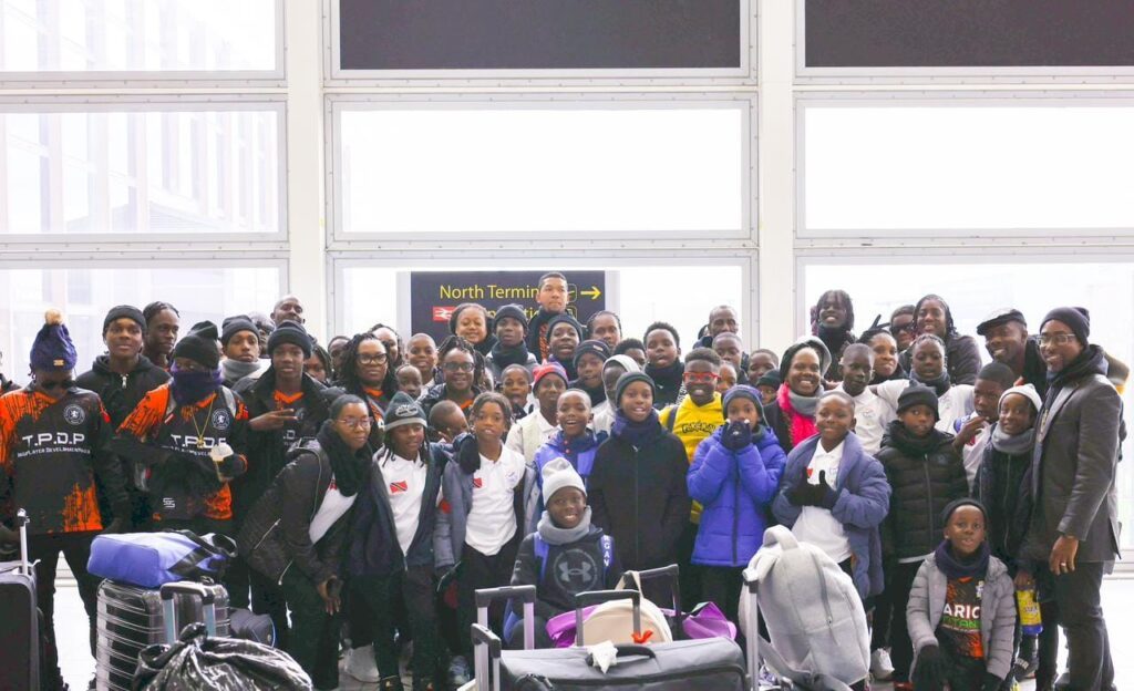 The young footballers from the Jaric Titans Sports Development Club and their chaperones at Heathrow Airport in England on March 27.  - Photo courtesy the Jaric Titans Sports Development Club's Facebook page.