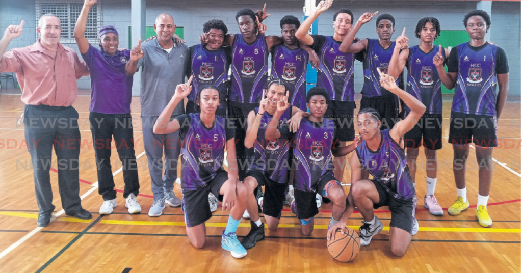 Holy Cross College principal Gary Ribeiro, from left, coach Michael Watkins and team manager Derek
Harold, with the Holy Cross Under-17 basketball players. Holy Cross defeated Hillview College to win
the East zone Under-17 title. PHOTO BY Jelani Beckles