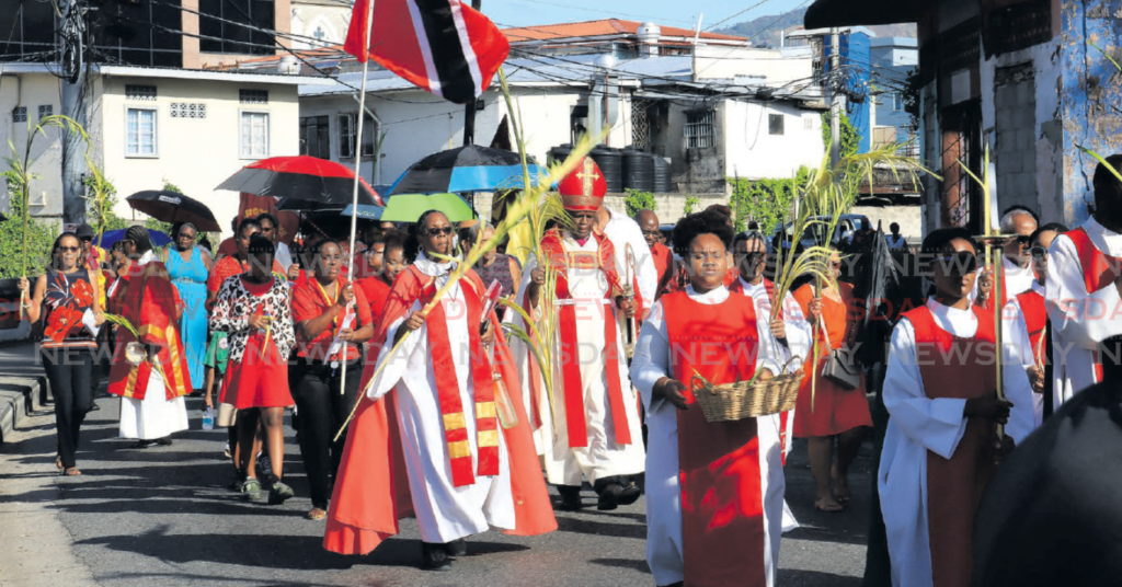 Anglican Bishop Claude Berkley, centre, leads a Palm Sunday procession through the streets of Port of
Spain on Sunday. The procession was hosted by Anglican members of the Holy Trinity Cathedral and
joined by Catholic members of the Cathedral of the Immaculate Conception. To the Bishop’s left is Rev
Dr Shelley-Ann Tenia. PHOTOS BY ROGER JACOB