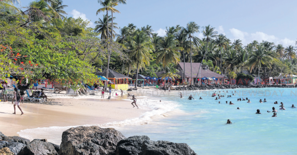FUN IN THE SUN: People enjoying themselves at Pigeon Point beach, Tobago. - File photo