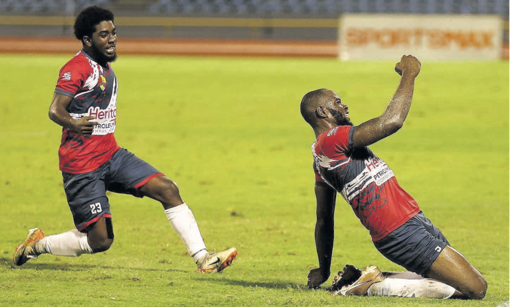 Point Fortin Civic’s Andre Etienne, right, celebrates the winner against Defence Force in a TTPFL match on
March 16 at the Hasely Crawford Stadium, Mucurapo. - Photo courtesy TTPFL