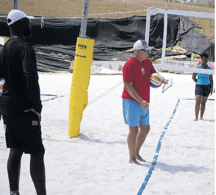 Instructor Rick Bevis, centre, engages participants at the TTVF international
beach volleyball course at Courland Beach Sports Facility in Black Rock,
Tobago on March 24. TT beach volleyball coach David Thomas. left, looks
on. - Photo courtesy TT VF