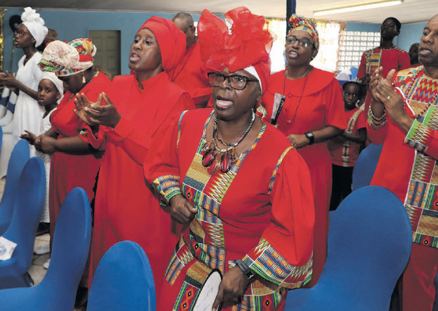 Members of the congregation sing at the Spiritual Shouter Baptist
Liberation Day celebrations, held at the Council of Elders Empowerment
Hall, Churchill Roosevelt Highway, Maloney on March 30.