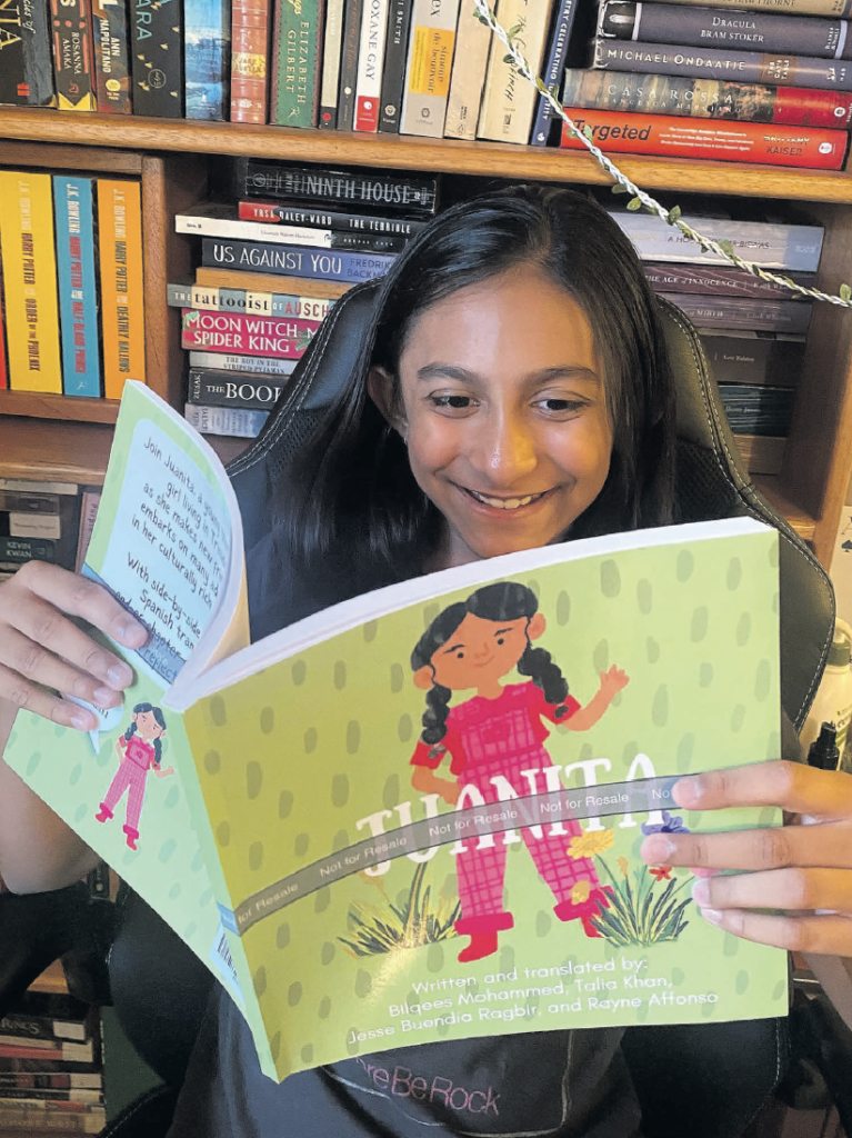 Skyler Affonso reads the bilingual children’s book, Juanita. PHOTO BY Rayne Affonso