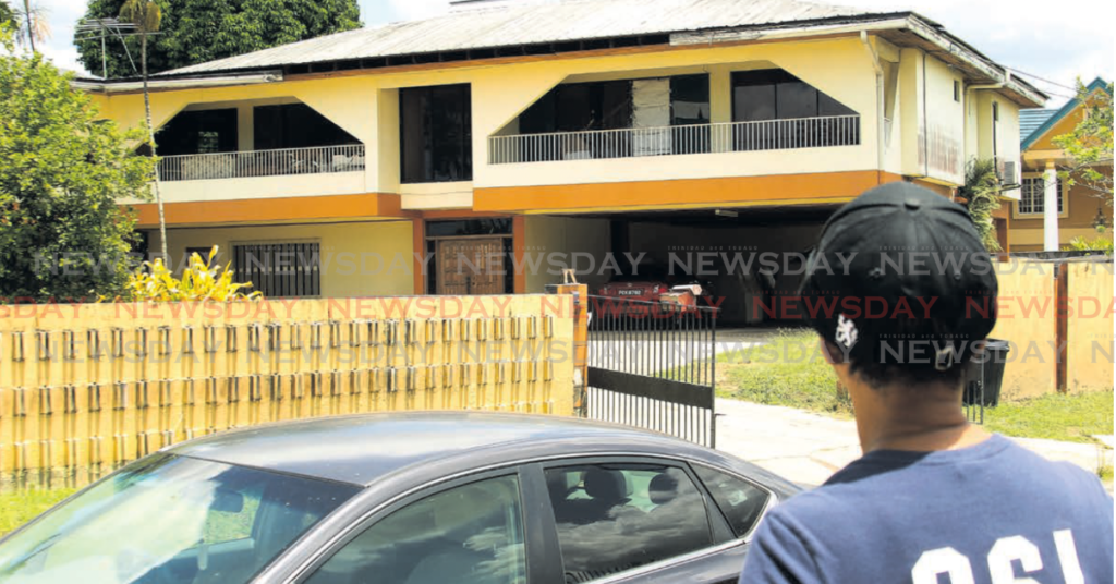 A Valsayn resident looks at the Butu Road house where Hannah
Mathura’s skeletal remains were found on March 12. - File photo