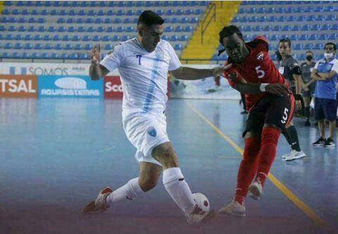 National futsal player Che Benny, right, in action against Guatemala at the Concacaf World Cup Futsal Championships. -File photo