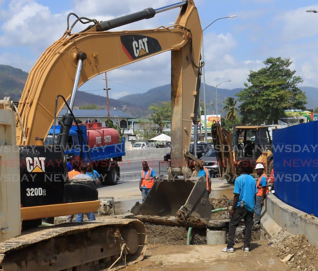 In this file photo, WASA workers excavate part of the road during emergency repairs to a broken pipeline near Valsayn in March. - Photo by Roger Jacob