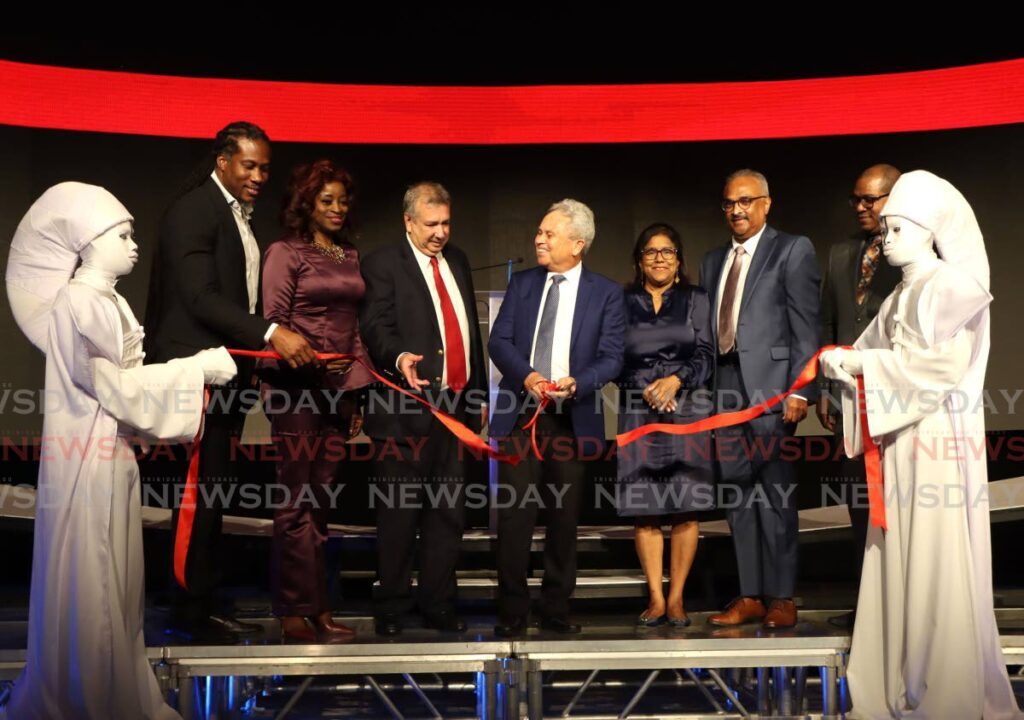 Finance Minister Colm Imbert, centre, cuts the ribbon during the TTMB brand launch at the Hyatt Regency, Port of Spain on March 20. - Photo by Ayanna Kinsale  