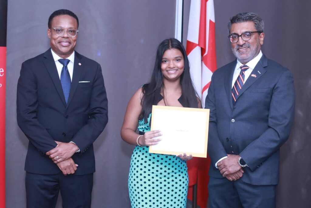 Angelina Beharry was awarded the diploma in French language studies (DELF Junior) at the reception for International Francophone Day. At left is Dr Amery Browne Minister of Foreign and Caricom Affairs and at right is Arif Keshani high commissioner for Canada. - GREVIC ALVARADO