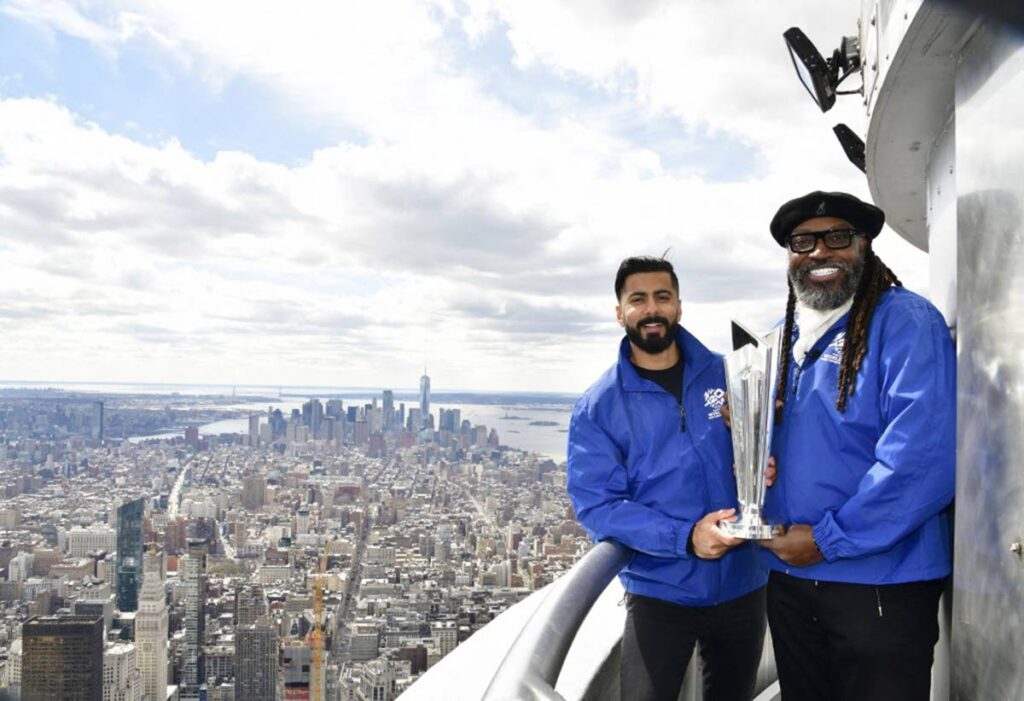 US cricketer Ali Khan, left, and West Indies legend Chris Gayle with the ICC World Cup trophy at the Empire State Building in celebration of the International Cricket Council's Trophy Tour on March 18, 2024 in New York City.  - AFP PHOTO