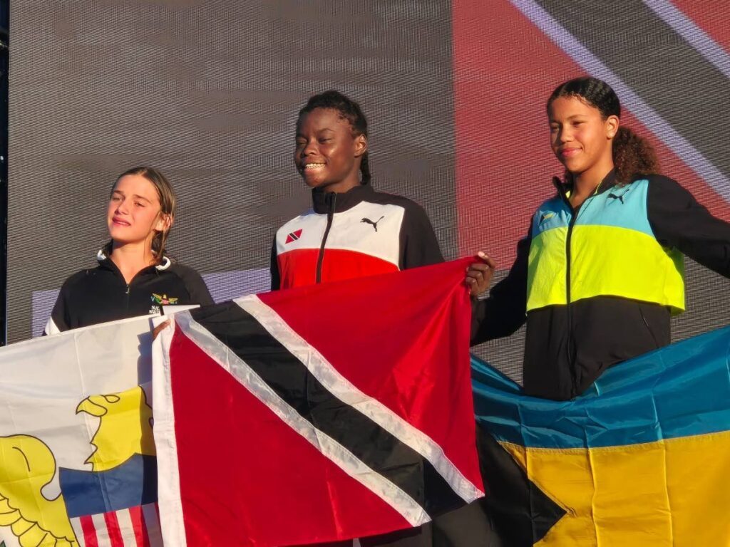 Zara Persico of TT, middle, after winning gold in the girls 11-12 200m freestyle event at the Carifta Swimming Aquatic Championships, held at the Betty Kelly-Kenning Aquatic Centre, Bahamas. -
