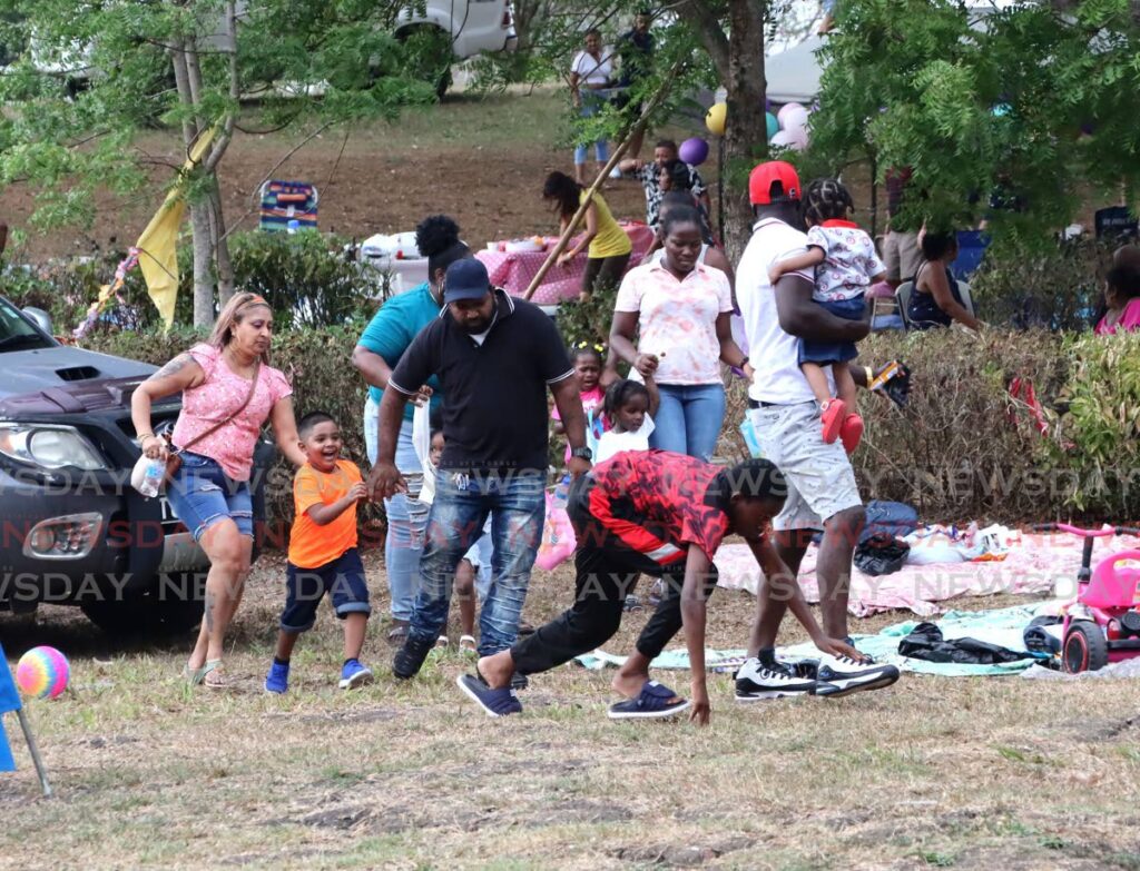 This group of people scampered to safety after four people were attacked by a swarm of bees at Palmiste Park, San Fernando on April 1. - Photo by Ayanna Kinsale