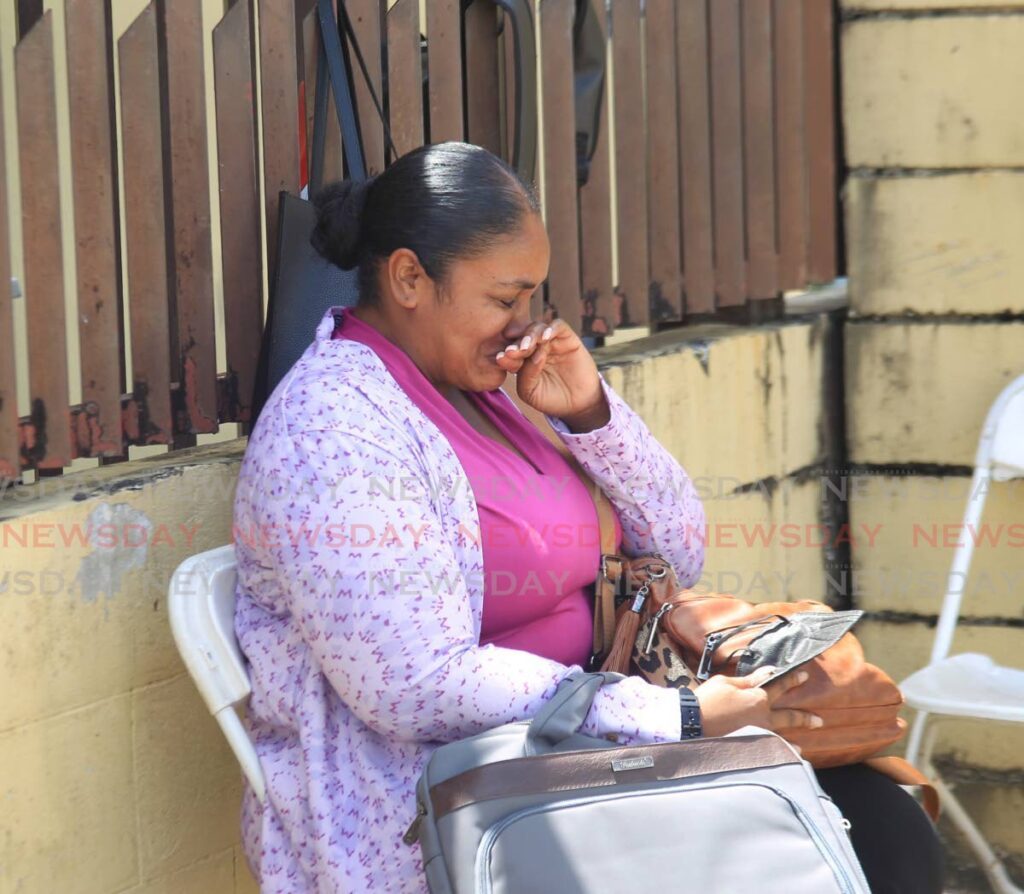 Afisha Glasgow, widow of retired prison officer Victor Williams, weeps as she waits for the results of his autopsy at the Forensic Science Centre, St James on Monday.  - Faith Ayoung