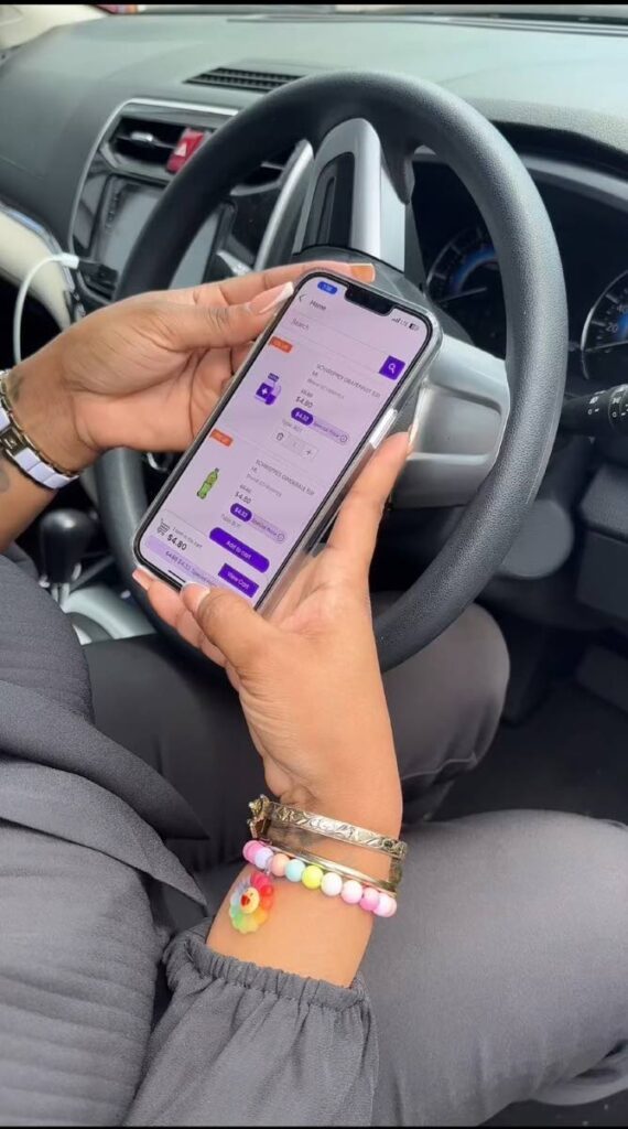 A user browses the Invent Life app while sitting in her vehicle - 