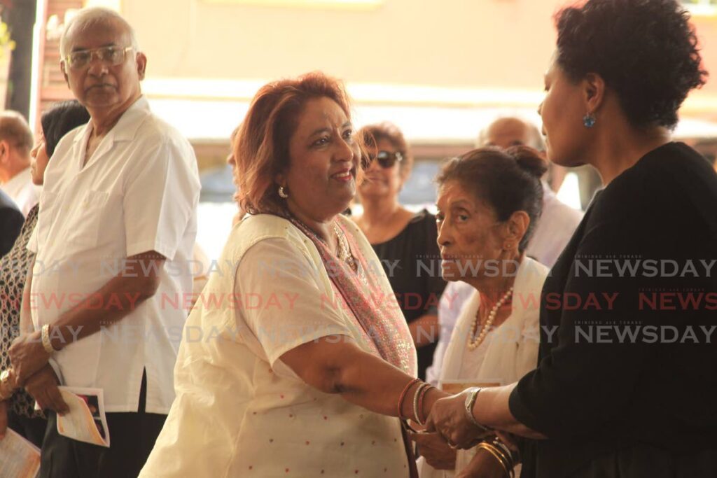 Mandavi Tiwary, the sister of retired justice Amrika Tiwary-Reddy, greets former president Paula Mae-Weekes at Tiwary-Reddy's funeral in Barataria on April 9. - Photo by Faith Ayoung