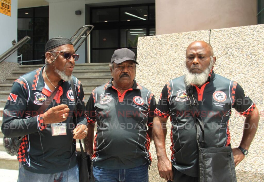 Executive members of the TT Taxi Drivers Network, from left,  David Mack , Dennis Jagessar and Adrian Acosta, during a protest outside Ministry of Works and Transport head office in Port of Spain on April 11.  - Faith Ayoung