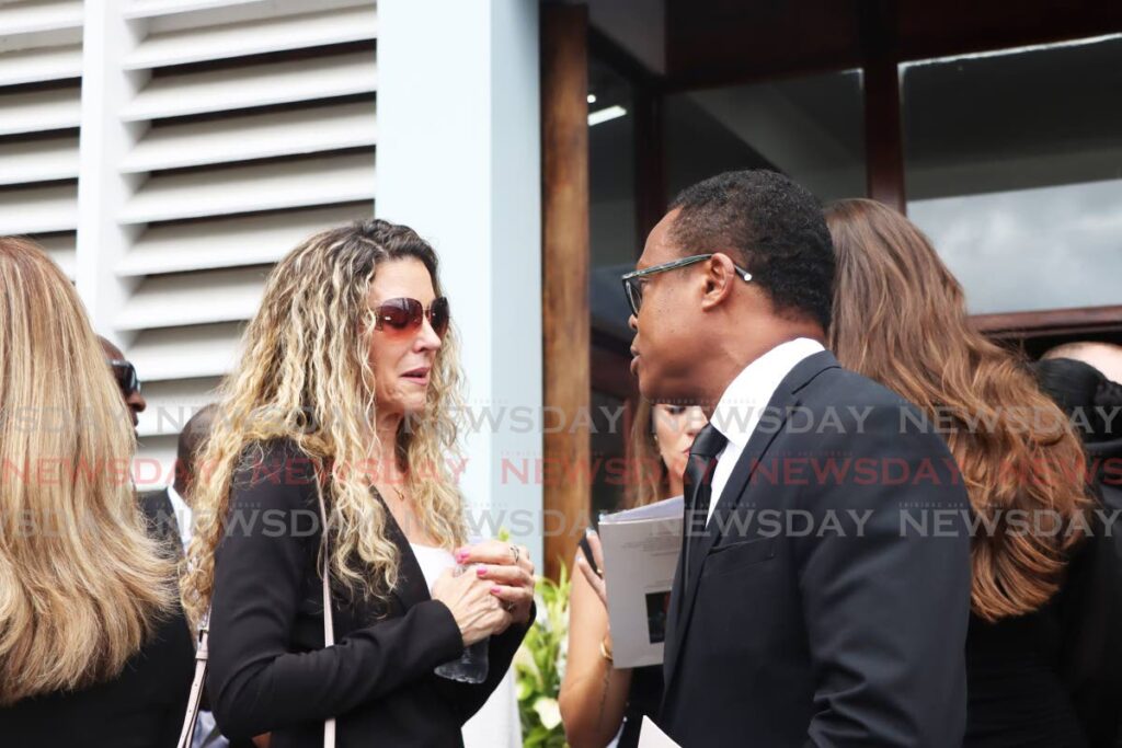 Juliet de la Bastide, left, daughter of former chief justice Michael de la Bastide speaks to Foreign Affairs Minister Dr Amery Browne at the Church of the Assumption, Maraval ,after her father's funeral on April 11. - Photo by Venessa Mohammed