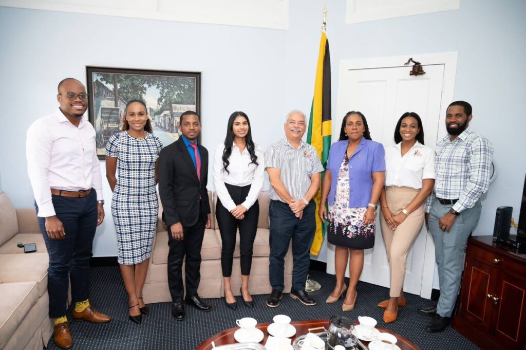 Jamaican High Commissioner to TT Natalie Campbell-Rodriques, third from right, with representatives of HADCO and The Best Dressed Chicken during a visit to the Jamaican High Commission in Port of Spain last month. - 