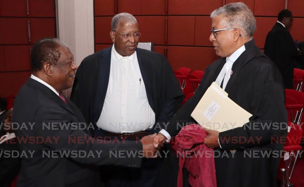 Former CCJ President Sir Dennis Byron, left, shakes the hand of Attorney General Reginald Amour, SC, while Organisation of Commonwealth Caribbean Bar President Donovan Walker looks on, at the joint appeal court and CCJ sitting to honour former chief justice the late Michael de la Bastide, at the Hall of Justice, Port of Spain on April 12. - Photo by Angelo Marcelle
