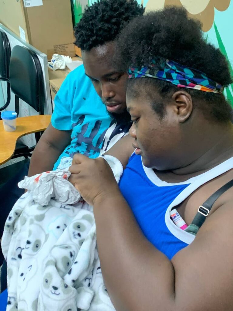 Shaniya Raymond-Adams and Kerron Charles, the parents of deceased baby Kae’ Jhene Kerniah Charles, mourn over her body at the Port of Spain General Hospital. Their baby was one of seven  who died between April 4-9 at the Neonatal Intensive Care Unit of the hospital.  - 