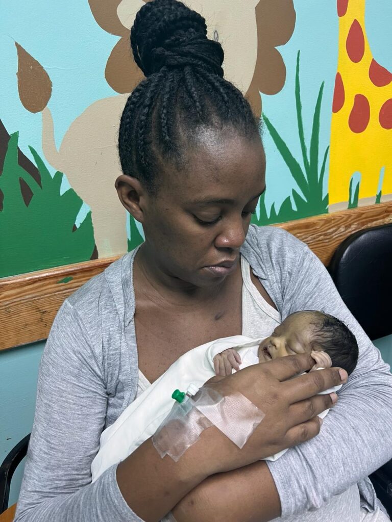 GRIEF: Tobago mom Shirese Moore-Beckles cradled her baby Crystell Precious Miracle before her death at the Port of Spain General Hospital. 