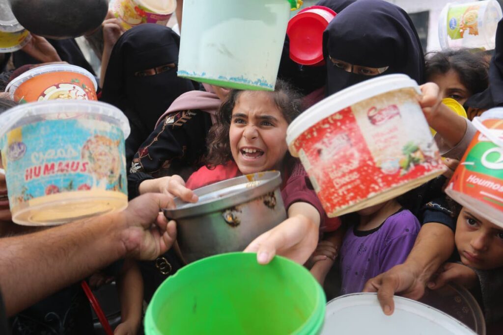 Palestinians line up for food during the ongoing Israeli bombardment of the Gaza Strip, in Rafah. AP PHOTO, File - 
