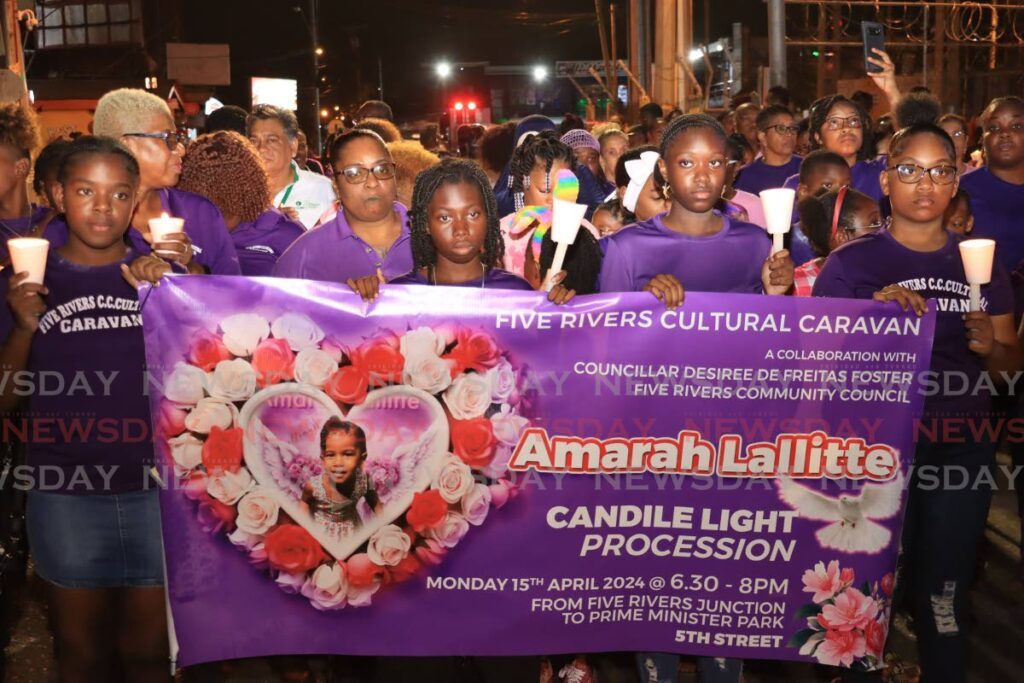 GONE TOO SOON: Members of the Five Rivers Cultural Caravan lead a candlelight procession in memory of murdered four-year-old Amarah Lallitte from Five Rivers Junction to Prime Minister Park, Five Rivers on Monday night.  - Photo by Roger Jacob