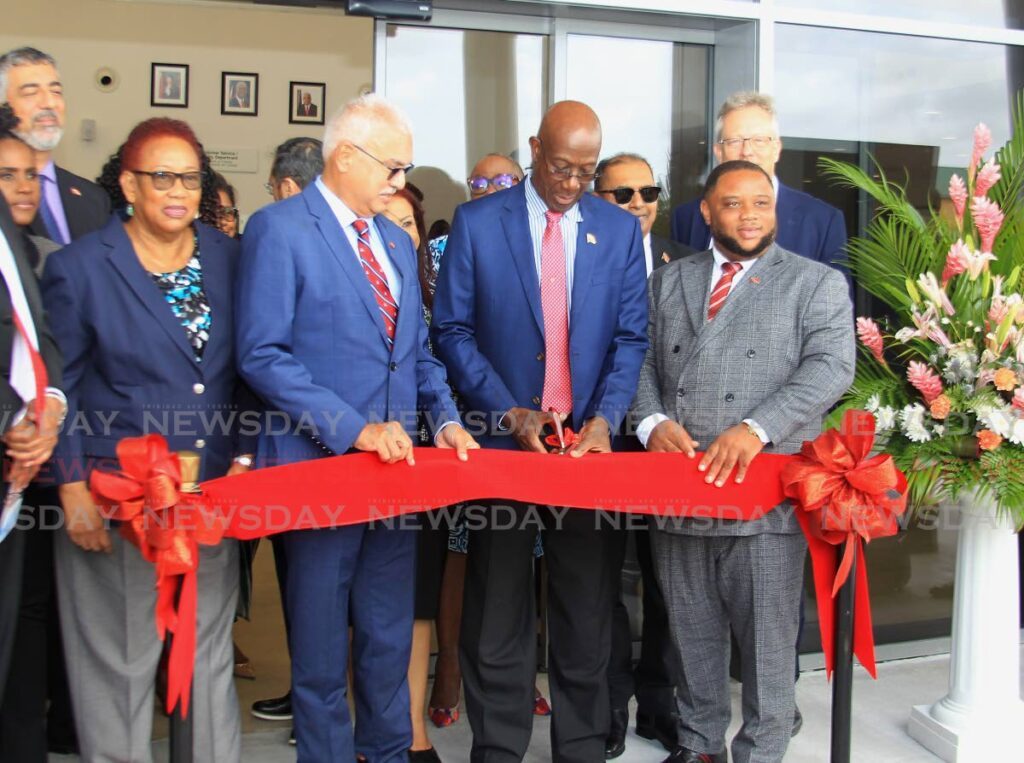 Prime Minister Dr Keith Rowley, second from right, cuts the ribbon with Minister of Health Terrence Deyalsingh, centre, MP for Toco/ Sangre Grande Roger Monroe, right, and other officials at the opening ceremony of the Sangre Grande Hospital Campus, Ojoe Road, Sangre Grande on Wednesday. - Faith Ayoung