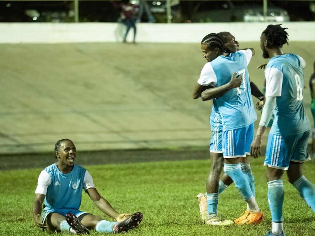 Eagles FC player Joshua Alexander, left, and his teammates celebrate a goal in TTPFL action at the Arima Velodrome. - Photo courtesy Trini Media. 