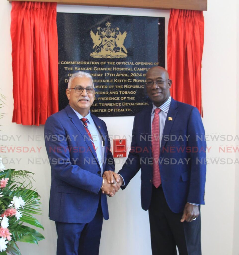 Minister of Health Terrence Deyalsingh, left, and Prime Minister Keith Rowley shake hands at the opening of the Sangre Grande Hospital Campus.  - Photo by Faith Ayoung