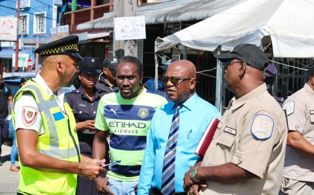 Mayor of Point Fortin Alderman Clyde James, second from right, engages with a member of the community and officers in Point Fortin. -  courtesy The Mayor’s Office of Point Fortin