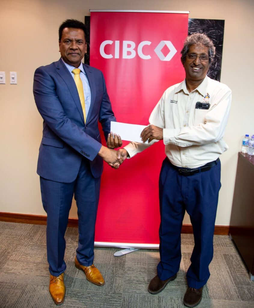Anthony Seeraj, managing director of CIBC Caribbean, presents a cheque to Prof Roger Hosein of Sure  Foundation.
Photo courtesy CIBC Caribbean. - 