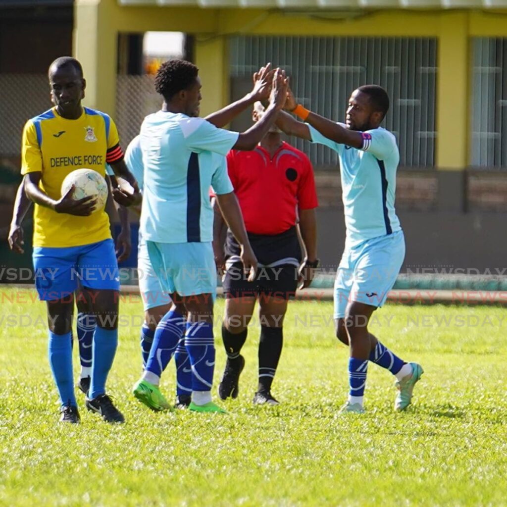 Police FC players (R) celebrate a goal versus Defence Force in a 2023 TTPFL tier two match, while opposing captain Jerwyn Batlhazar strolls away. Photo courtesy TTPFL.  - 