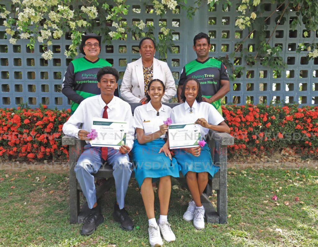 Winners of the Earth Day 2024 Video Competition: Hillview College, St. Joseph's Convent (St. Joseph) and Bishop's High School (Tobago), pose for a photo with the Minister of Planning and Development Penelope Beckles-Robinson, middle, and members of Flying Tree Environmental Management at the Earth Day Exhibition 2024, held at the University Inn and Conference Centre, St. Augustine on April 22. - Photo by Venessa Mohammed