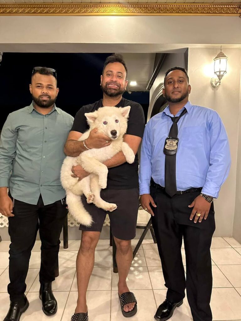 Ravi B, centre, holds his dog Lily after officers helped find her. She was stolen on April 23.  - Photo taken from Ravi B's Facebook 