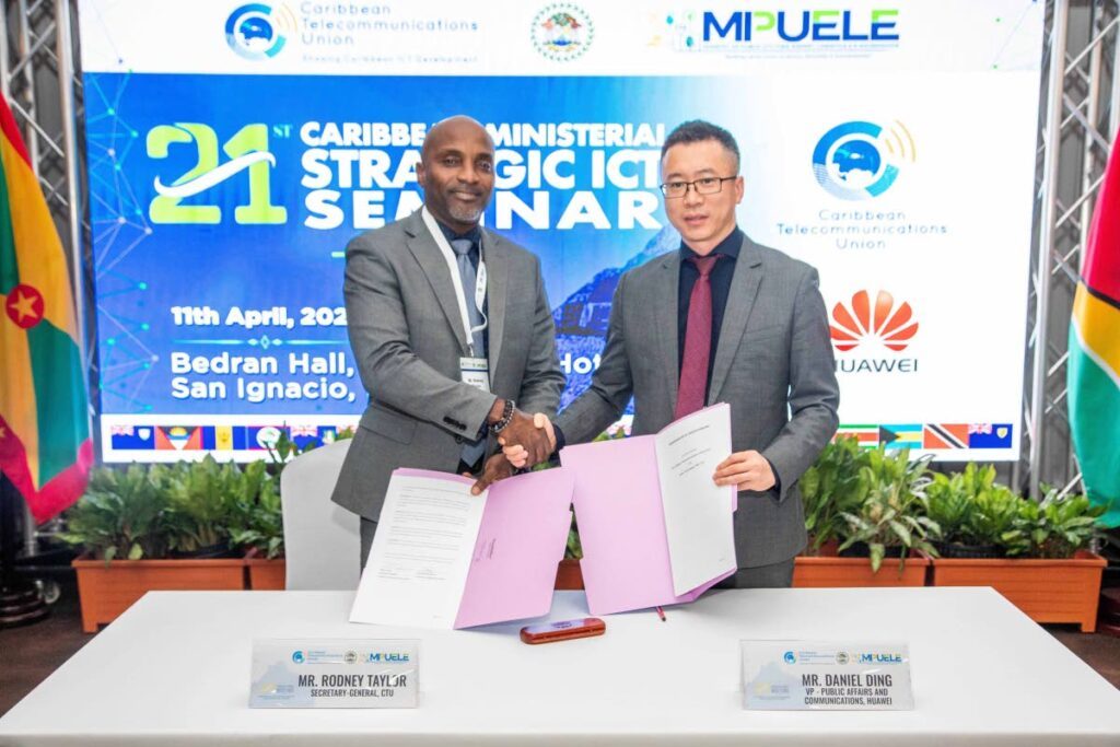 Rodney Taylor, secretary general of the CTU, left, shakes hands with Daniel Ding, Huawei's VP-public affairs and communications, after signing the co-operation MoU. - 
Photo courtesy Huawei TT 