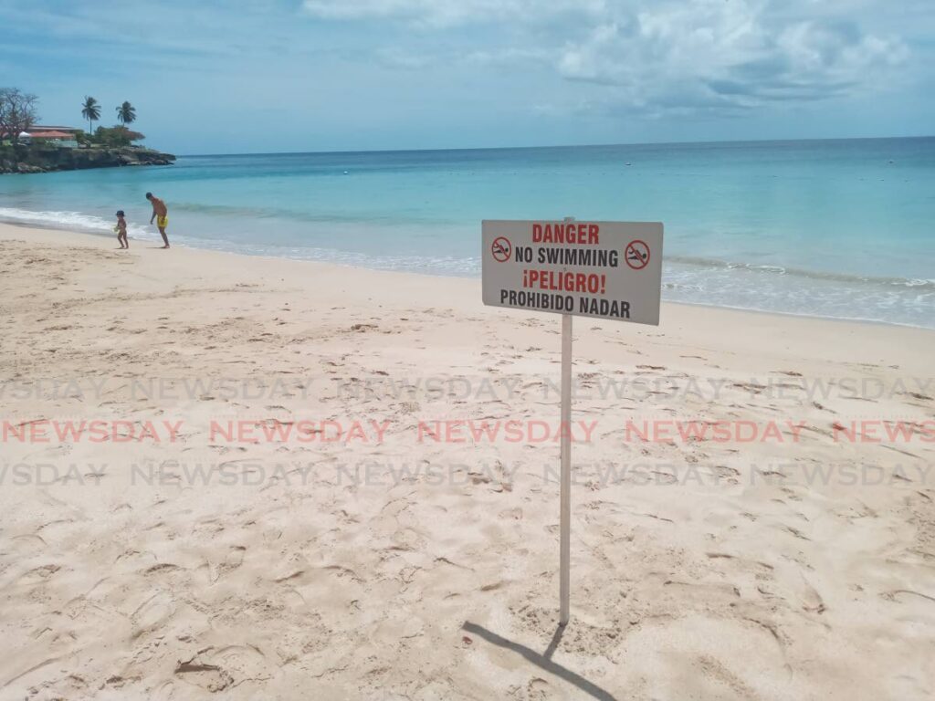 A warning sign erected at Store Bay. Several beaches along the northwestern coast were ordered closed on April 26 after a British toursit was bitten by a bull shark near Starfish resort.  - Corey Connelly