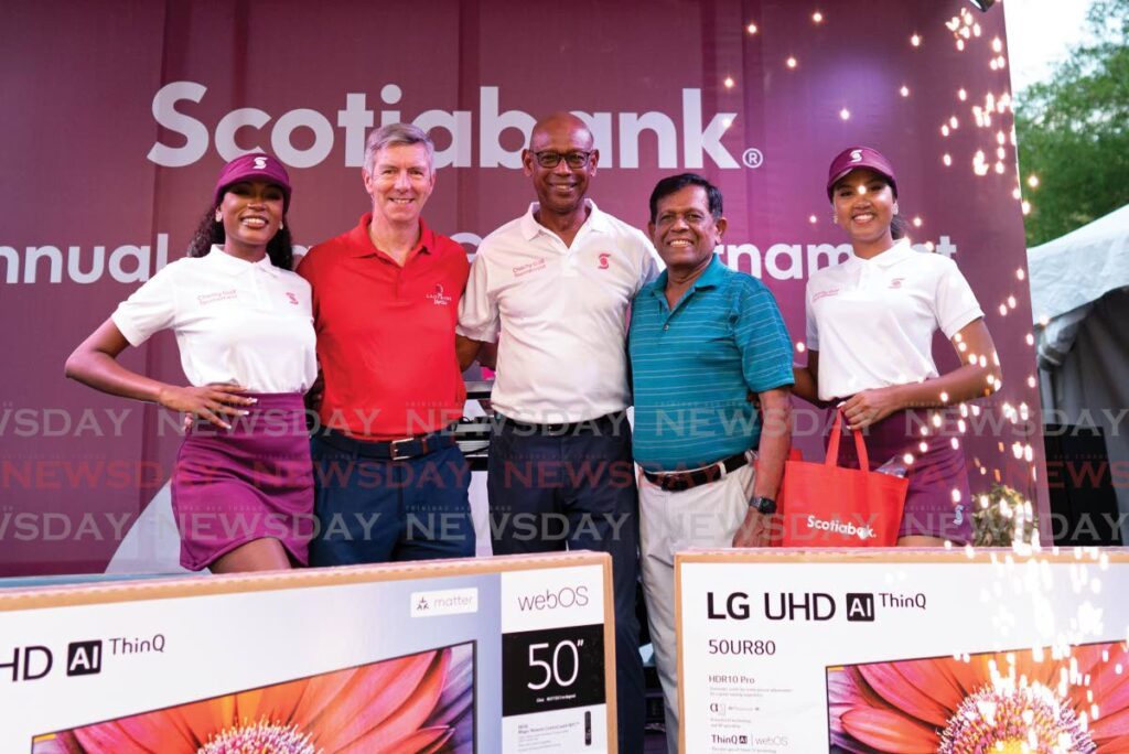 Derek Hudson, chairman, Scotiabank (centre), with Team Music Radio 97 players Takoor Ramnath and David Campbell who placed second at the 22nd Scotiabank Charity Golf tournament - 
