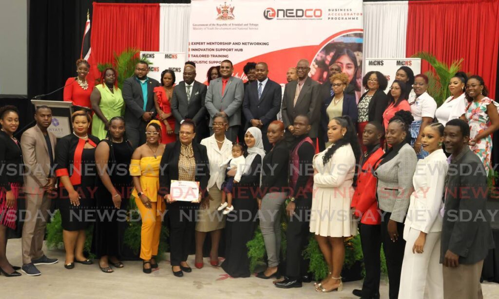 Foster Cummings, MYDNS Minister, centre, poses with senior Nedco officials and graduates of the Business Accelerator Programme, at Hyatt Regency, on April 30. - Photo by Roger Jacob