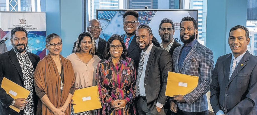 Eleven music industry professionals who received grants from Music TT
with Ministry of Trade and Industry Paula Gopee-Scoon, centre,
at the distribution ceremony.