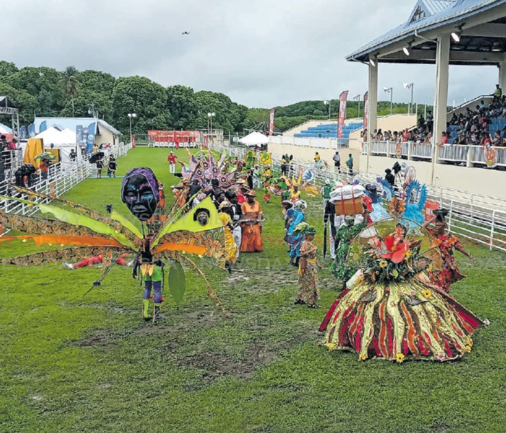 Carnival and folklore characters, which were part of the street parade,
dance on the main race track at the Buccoo Integrated Facility on April 2. - Photo by Corey Connelly